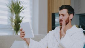 Young attractive man at home waving his hands speaking on video call with his friend. Stay at home. Communication conference portrait social media. Slow motion