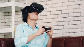 Asian man wearing virtual reality glasses experiencing innovative technology in the modern home, a handsome man playing the game using VR glasses on a sunny day.