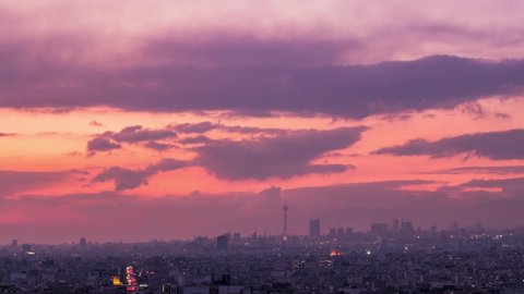 4K Tehran city skyline day to night Time lapse with an amazing sunset and lovely clouds in the sky and Milad tower in frame.