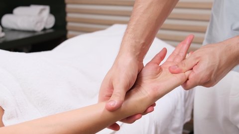 Procedure hands massage in the spa salon.Hand Care in the beauty salon. Massage the fingers and wrist in a spa salon. Spa manicure procedure.