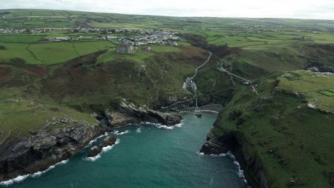 Aerial View Of Peninsula Of Tintagel Island With Camelot Castle Hotel, Tintagel Castle, And Village In Cornwall, United Kingdom.