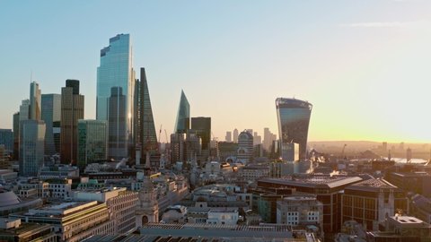 Aerial slider shot of Central London skyscraper buildings and canary wharf at sunrise