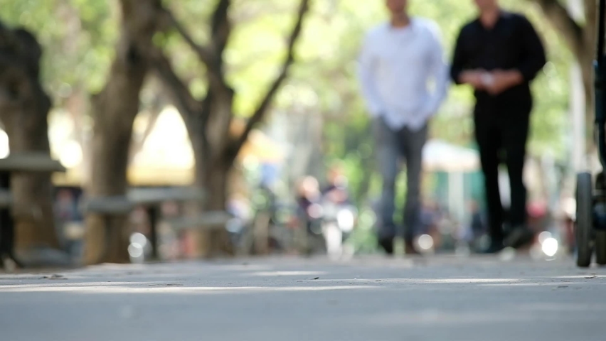 A low angle on the pavement showing people