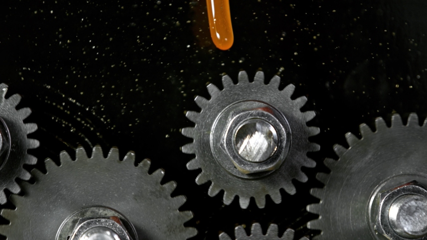 Super Slow Motion Shot of Gear Mechanism and Oil on Dark Background at 1000 fps. | Shutterstock HD Video #1063513303