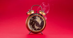 Concept video - there is freshly brewed coffee in the dial of the alarm clock, steam is coming. Red background