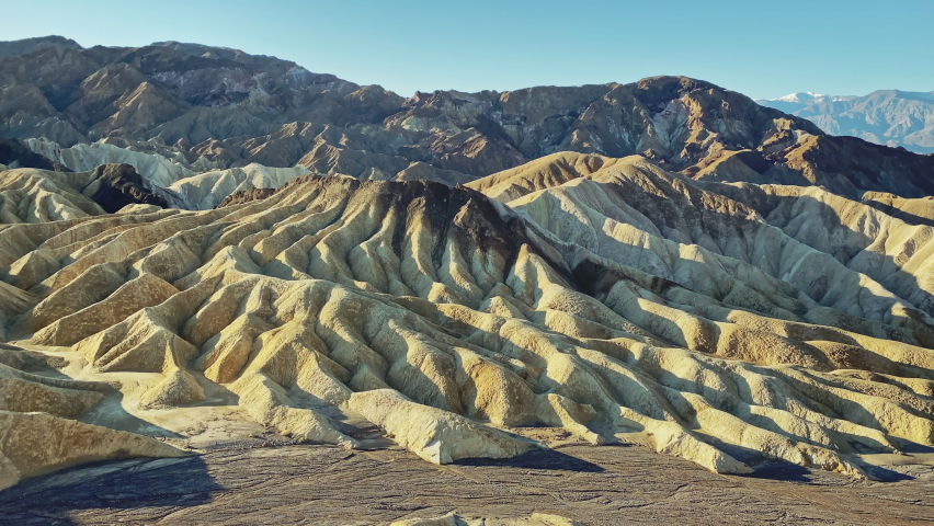 Scenic sunrise over the desert canyons from Zabriskie Point at Death Valley National Park, California, USA. Pan left to right.