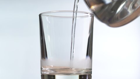 Pour hot water into a glass.