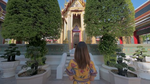 Woman in dress visiting Wat Ratchabophit temple the famous tourist attraction in Bangkok, Thailand