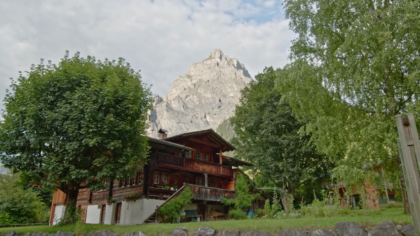 Timelapse view on typical swiss house with mountain at the background. Kandersteg. Kandertal. Bernese Oberland. Canton Bern. Switzerland.