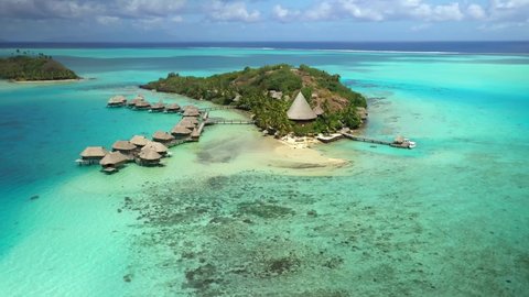 4k drone Bora Bora Tahiti. Aerial view of overwater bungalow villas in lagoon, French Polynesia. Luxury travel vacation, paradise island getaway, romantic honeymoon exotic destination.  : film stockowy