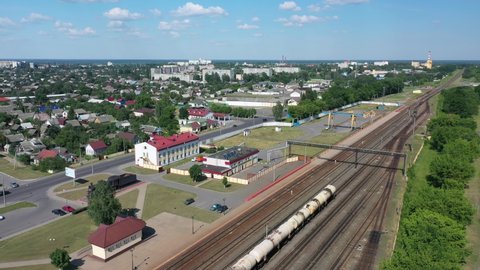 Railroad or railroad tracks for rail transport. railway tracks with trains going in industrial area. aerial photo from flying drone. The train tanks with oil and fuel.