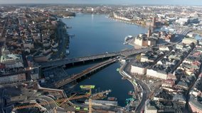 Aerial flying above Slussen in Stockholm with views of Old Town and Sodermalm. 