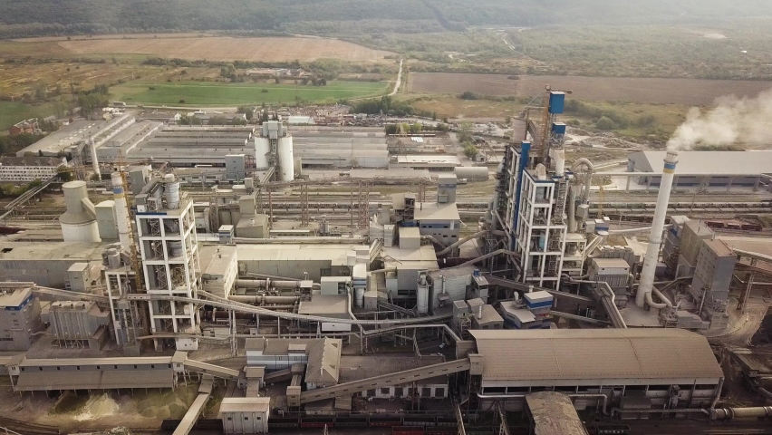 Aerial view of cement plant factory at industrial production area. Royalty-Free Stock Footage #1063541122