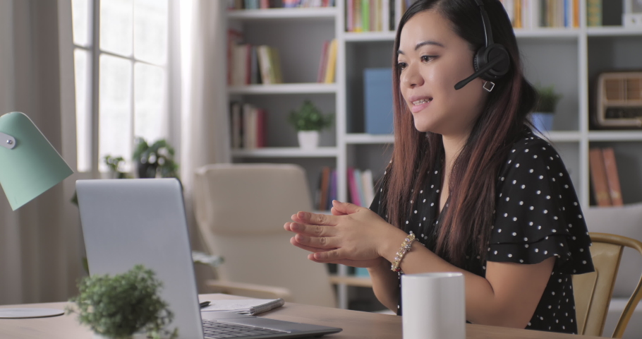 Chinese businesswoman distance working video call conference,asian adult female talking speaking in a webinar with her work team group online videocall