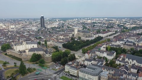 Aerial view of historic area of Nantes overlooking medieval Castle of Dukes of Brittany, Gothic Roman Catholic cathedral with Tour Bretagne on background, France