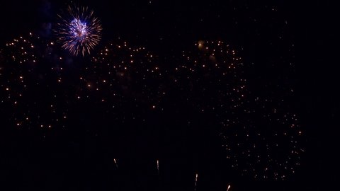 A huge fireworks display fills the night sky.