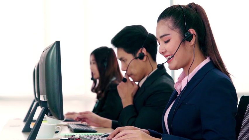 Business people wearing headset working in office to support remote customer or colleague. Call center, telemarketing, customer support agent provide service on telephone video conference call. | Shutterstock HD Video #1063545667