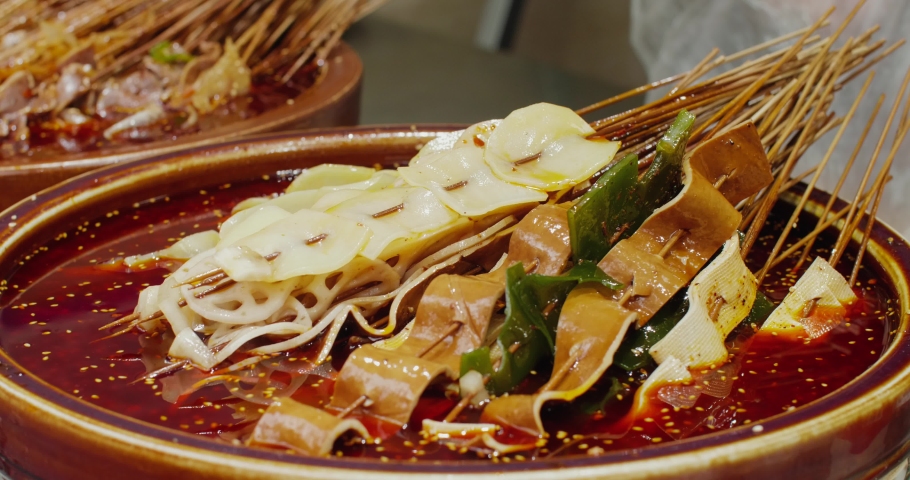 Close up Leshan BoBoji local version of mala tang of Sichuan cook different food together with bamboo stick in the spicy red chilli soup travel street food at Chengdu China