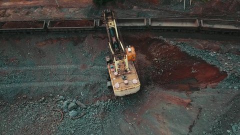 Excavator quarry loading train iron ore industry mining.