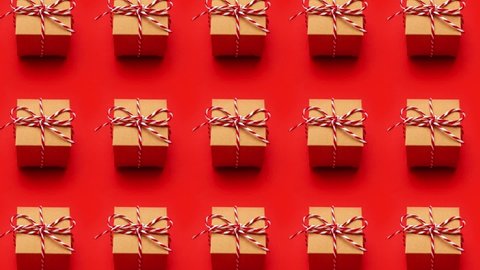 Christmas gift on a colored red background. New Year, holiday, give, pack pattern stopmotion