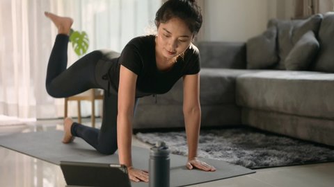 woman in sportswear doing workout at home. Video Stok