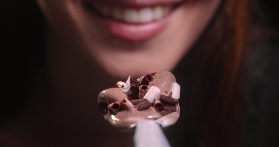 Young woman mouth eating chocolate ice cream Royalty-Free Stock Footage #1063569721