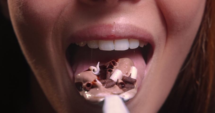 Young woman mouth eating chocolate ice cream | Shutterstock HD Video #1063569721