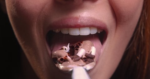 Young woman mouth eating chocolate ice cream