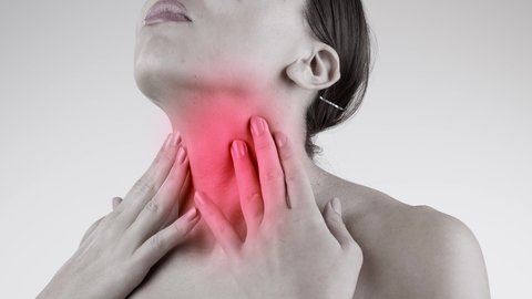 Sick woman suffer from sore throat, painful swallowing, tonsillitis, irritation. Female patient check thyroid gland by herself, rubbing with hand on her neck, laryngitis, bacterial infections diseases