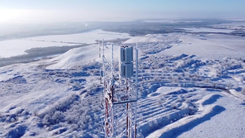 North. Mobile antenna in the snow. Snow all around. Flying a drone around the TV tower. Everything is frozen. Royalty-Free Stock Footage #1063577959