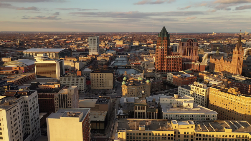 Aerial view of American city at sunset. Modern buildings, skyscrapers. Cloudy sky, cityscape. Milwaukee, Wisconsin Royalty-Free Stock Footage #1063582036