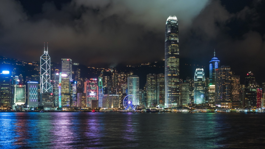 Hong Kong, China, zoom out time lapse view of famous Hong Kong skyline and Victoria Harbour at night.  | Shutterstock HD Video #1063582060
