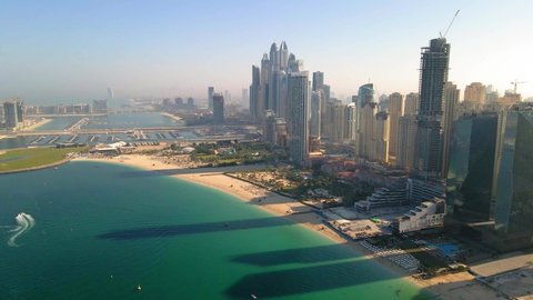 Dubai, United Arab Emirates - December 5, 2020: Aerial view of JBR beach and Dubai Marina skyscrapers and luxury buildings in one of the United Arab Emirates travel spots and resorts in Dubai