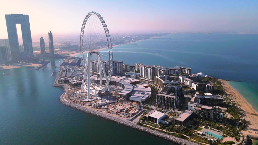 Dubai, United Arab Emirates - December 5, 2020: Bluewaters island and Ain Dubai ferris wheel on in Dubai, United Arab Emirates aerial footage. New leisure and residential area in Dubai marina area