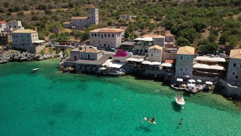 Aerial drone video of beautiful small seaside village of Limeni with emerald clear sea, Mani Peninsula, Lakonia, Peloponnese, Greece