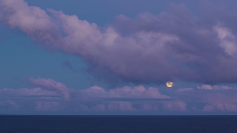 Full moon, moon time lapse, moonlight, clouds and moon, evening, blue sky, ocean and pink clouds.
Wonderful Evening in Tenerife with Moonrise on Blue Sky.