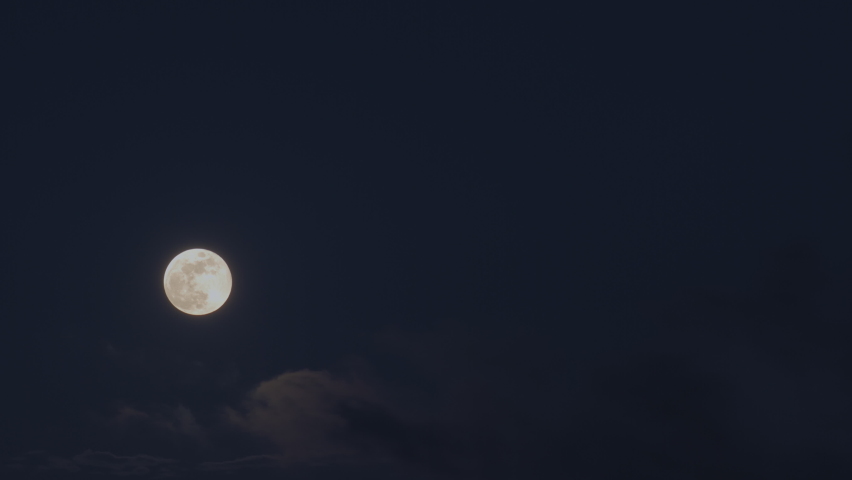 Clouds passing by moon at night. Full moon at night with cloud real time. mystery fairyland scene.
 | Shutterstock HD Video #1063588240