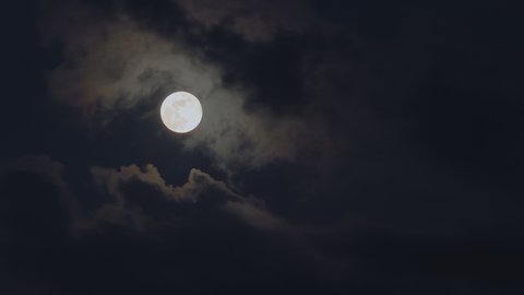 Clouds passing by moon at night. Full moon at night with cloud real time. mystery fairyland scene.

