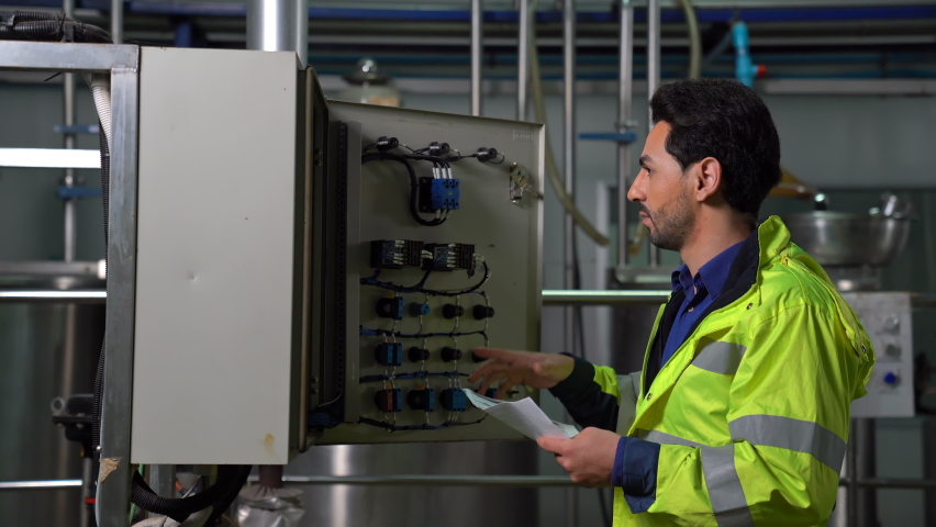 Industrial Engineer at work inspecting cabling and connection electric line in Industry Manufacturing Factory fuseboard. Royalty-Free Stock Footage #1063588909