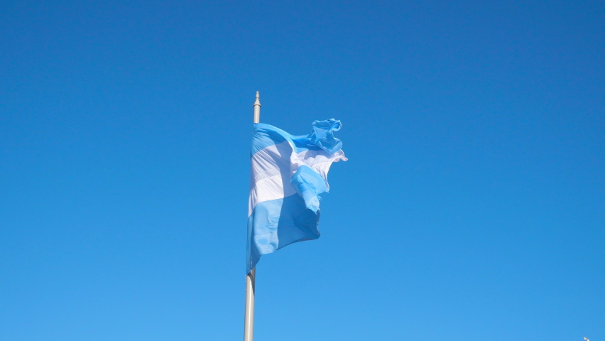 The Flag of Argentina waving in the wind against a blue sky. Royalty-Free Stock Footage #1063591438