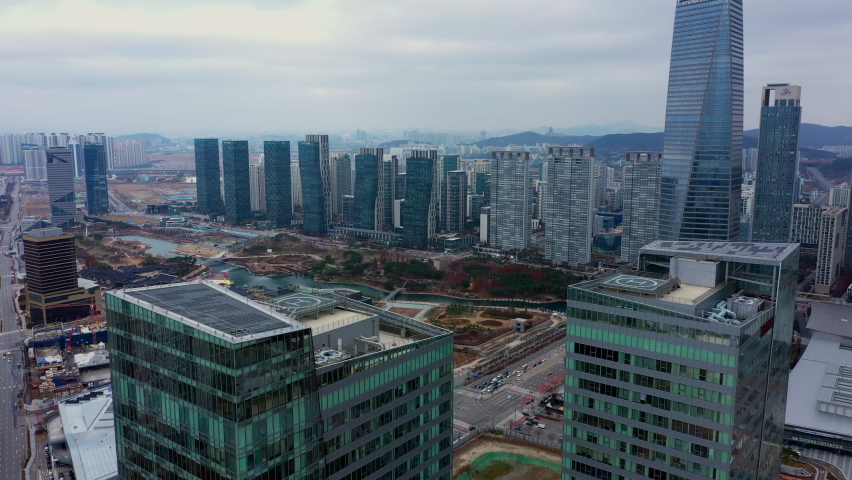 View of apartment complex near Songdo Central Park, Korea, drone shot. Cloudy day. Winter.