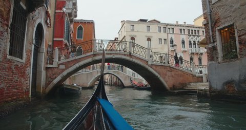 Riding on a gondola through the antique channels or canals of the city of Venice, Italy