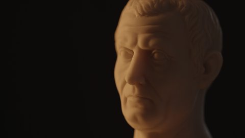 Ruler of Rome - Emperor Julius Caesar historical marble bust on black background