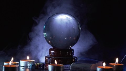 Magical fortune teller's glass ball for predicting and telling the future. Smoke around.