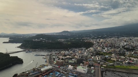 4K Aerial View of Seogwipo Port Area, Jeju Volcanic Island.
Seogwipo Tourist Port, Jeju Volcanic Island, a UNESCO World Heritage site.