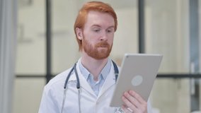 Portrait of Video Chat on Tablet by Redhead Male Doctor