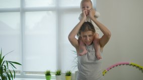 Mother Woman Doing Fitness At Home Together With Her Little Baby