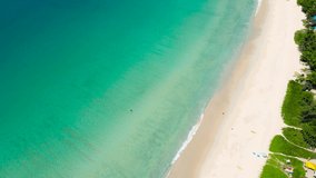 4K Phuket Thailand. Aerial view of Tropical aerial landscape with girls. Tanning woman wearing sun hat at the beach on a white sand shot from above. Azure water, sandy Tropical Beach. Top view, loop