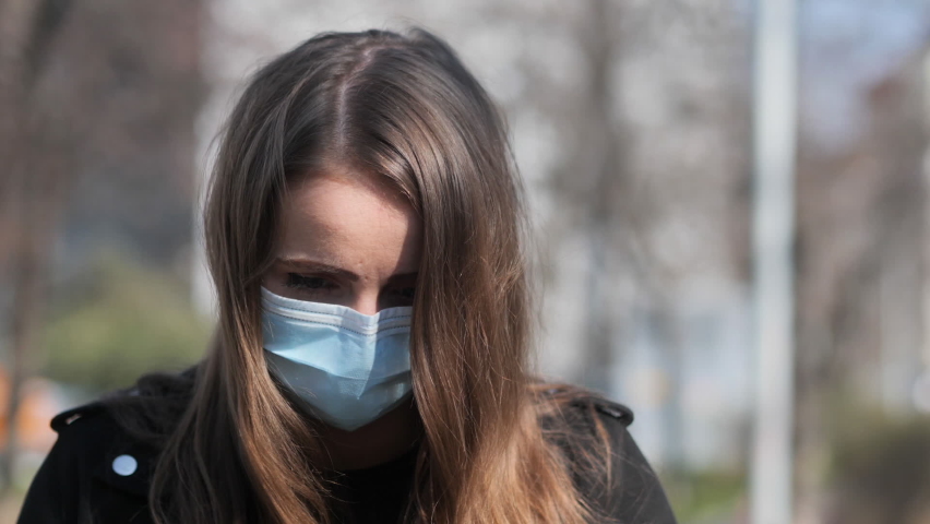 Sad Eyes Behind Face Mask of Young Woman Walking in City Outdoor During Covid-19 Virus Pandemic Looking At Camera, Slow Motion Royalty-Free Stock Footage #1063624690
