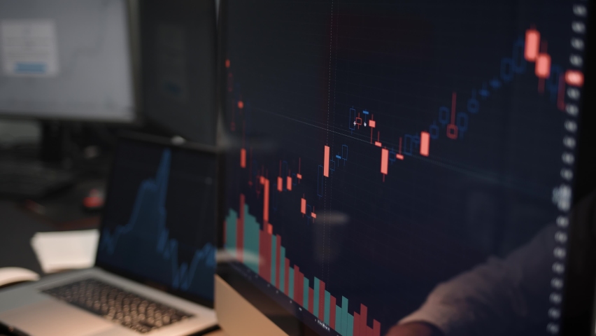 Computer screen with stock market changes, scrolling and analysing numbers. Man and computer display, no face, stock market with green and red market changes Royalty-Free Stock Footage #1063630909